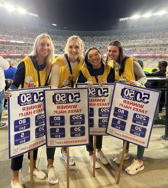 Four people working to sell raffle tickets